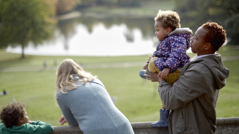 A family enjoying the view at Claremont Landscape Garden, Surrey